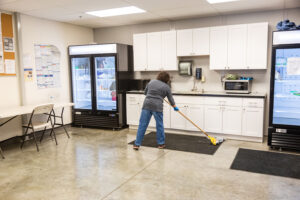 5 Star Janitorial employee sweeps the floor
