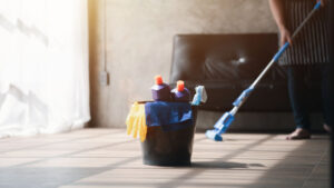 A professional move-in cleaner is cleaning the floor at a new house